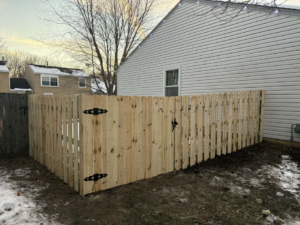 A new wood privacy fence with a matching gate installed next to a house by GoldHammer in Sebastopol, CA.