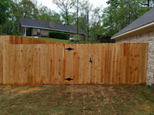 A sturdy wooden privacy fence with a functional gate installed by ICT Fence in Wichita, KS.