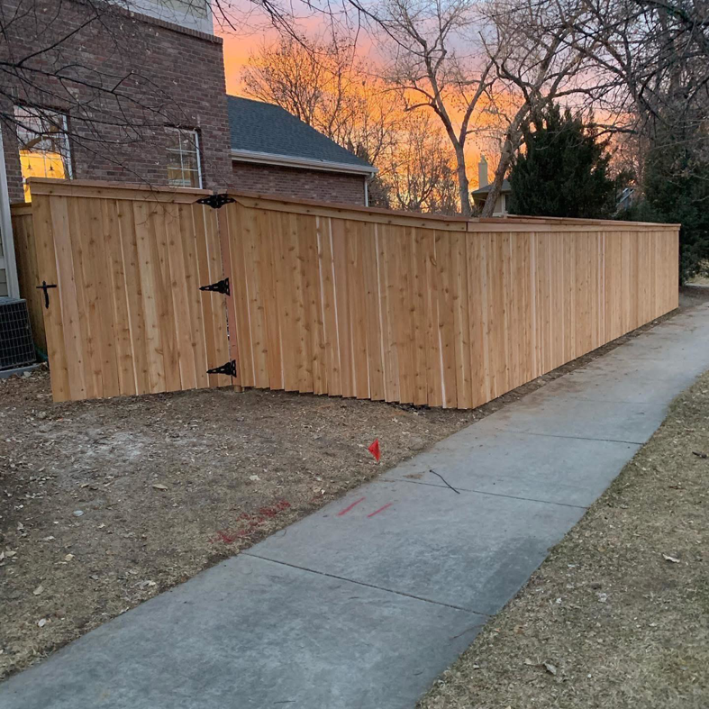 A custom wood privacy fence with a gate, expertly installed by Solid Fence LLC in Golden, CO.