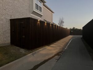 A wood privacy fence with integrated top lighting for enhanced security by Franco Fence in Garland, TX.