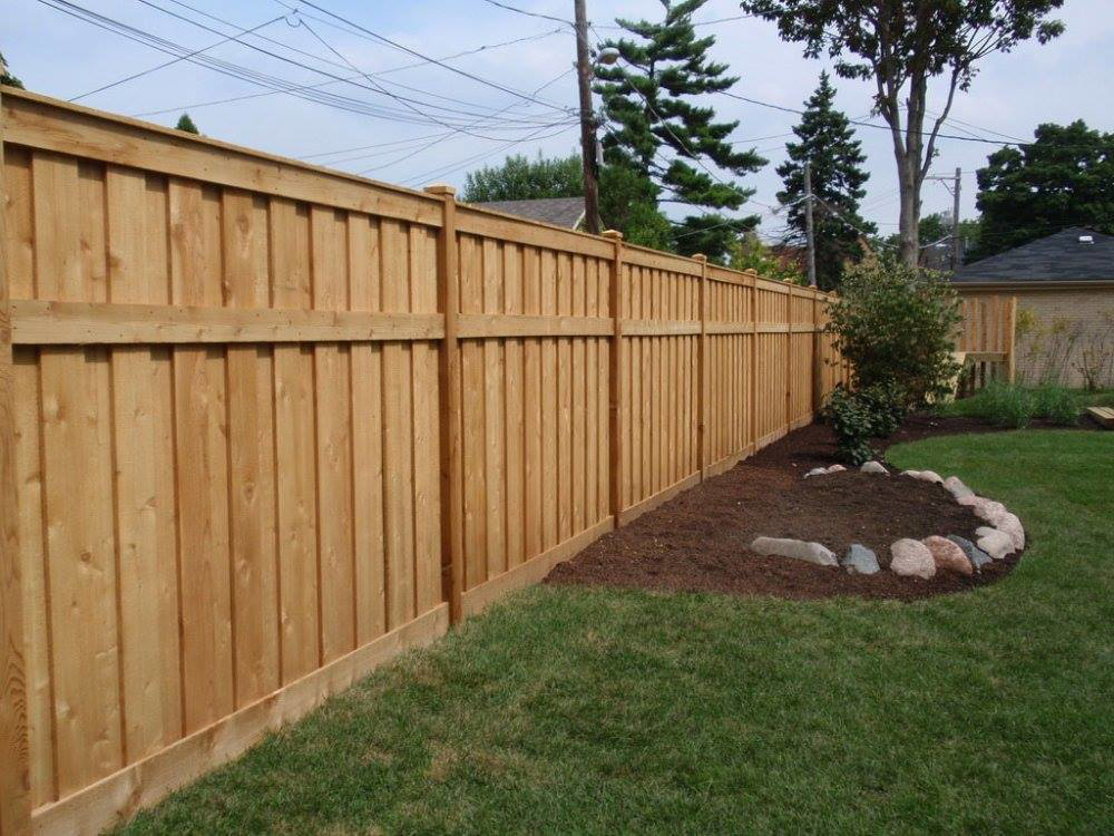 A new wood privacy fence with decorative landscaping installed by AmeriDream Fence & Deck in Joliet, IL.