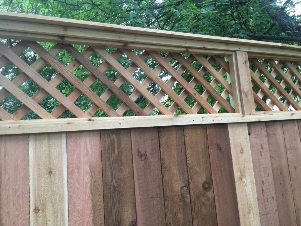 A newly installed wood privacy fence with a decorative lattice top by City Fence Co of San Antonio, TX