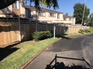 A long wood privacy fence with a lattice top installed along a road by No Limit Fence Company in Huntington Beach, CA.