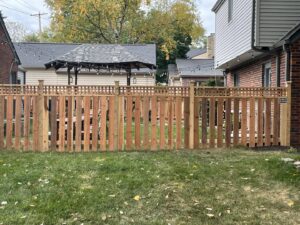 A beautiful wooden privacy fence with a decorative lattice top, installed by Rio Fence Co. in Lincoln, NE.