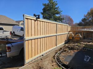 A wood privacy fence with a metal frame, recently installed by Straight Shot Solutions, LLC in Fort Worth, TX.