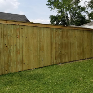 A sturdy wood privacy fence with a decorative top cap installed by Weber Fence LLC in Baton Rouge, LA.