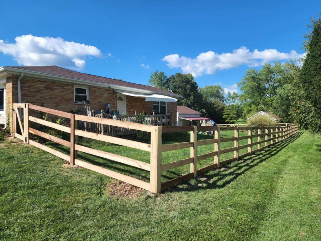 A newly installed wood rail fence with wire mesh by Barney's Landscaping in Dayton, OH.