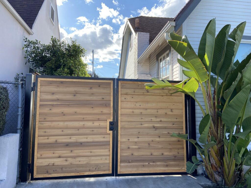A newly installed wood slat driveway gate by Los Angeles Fence Builders, enhancing property access in Los Angeles, CA.