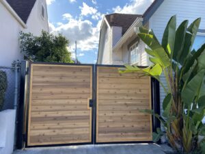 A newly installed wood slat driveway gate by Los Angeles Fence Builders, enhancing property access in Los Angeles, CA.