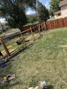 A wood split-rail fence under construction in a residential yard by HG Fencing LLC in Fountain, CO.
