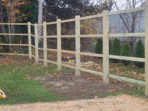 A newly installed wood split-rail fence by Camp Carlson Fencing in Rochester, NY, providing a rustic boundary.