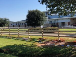 A new wood split rail fence being installed, showcasing the work of National Fence Services, LLC in Macon, GA.