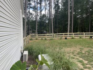 A long section of wood split-rail fence with wire mesh, installed by Superior Fence & Rail Richmond, VA.