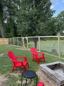 A wood and wire mesh fence installed around a backyard pond by Sea Level Fence in Harbinger, NC