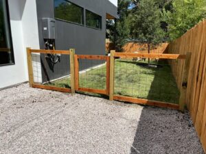 A custom wood and wire mesh fence with panels installed by Good Neighbor Fencing and Construction in Austin, TX.