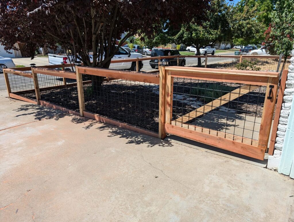 A wood and wire mesh fence with a matching gate installed by Sacramento Valley Fencing in Sacramento, CA.