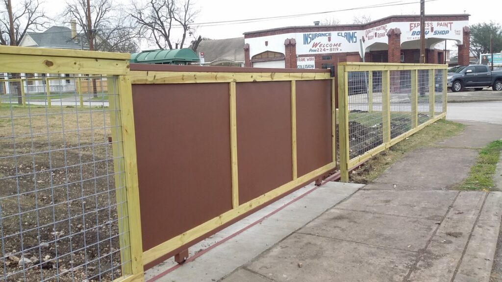 A custom wood and wire mesh sliding fence and gate installed along a street by Serrato's Fence & Welding in San Antonio, TX.