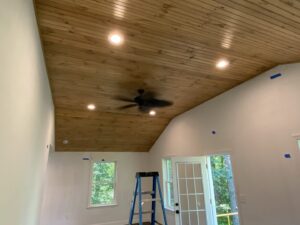 Recessed lighting and a ceiling fan installed on a beautiful wooden ceiling by Abe Electric LLC in Wallingford, CT.