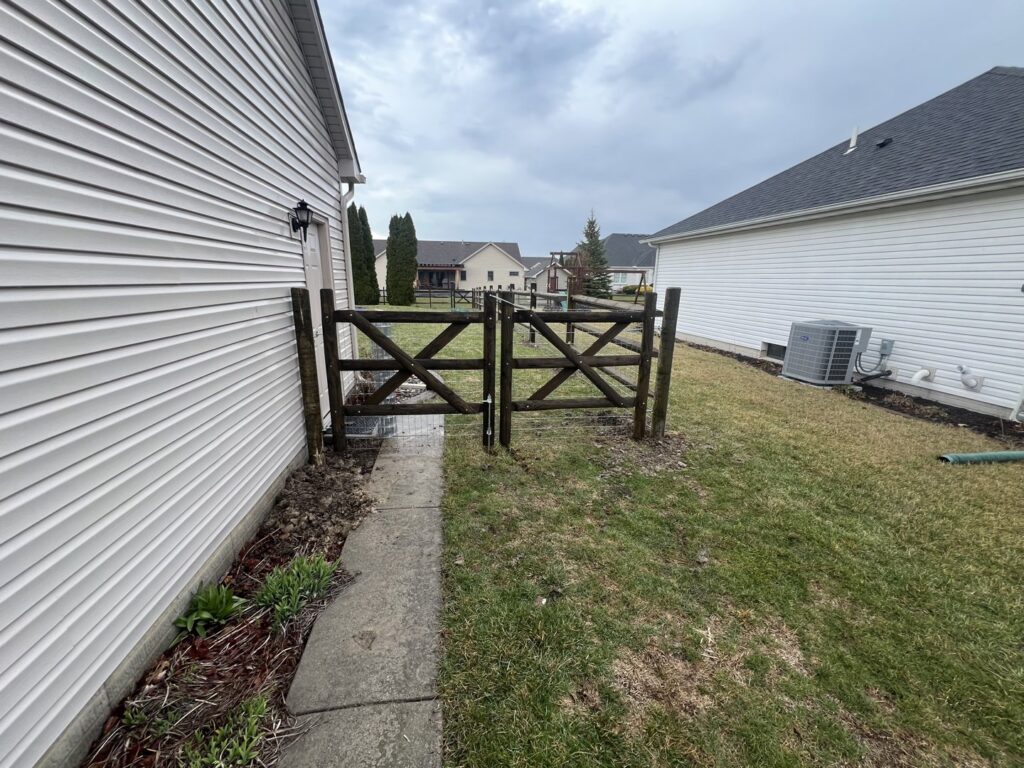 A custom wooden cross-brace gate installed by Premier Fence LLC in Canton, MA.