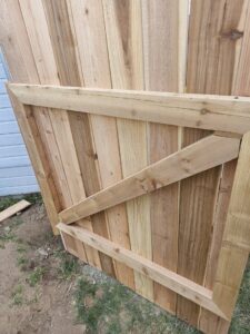 A wooden fence gate under construction or installation by Border Fence, Inc. in Greeley, CO.