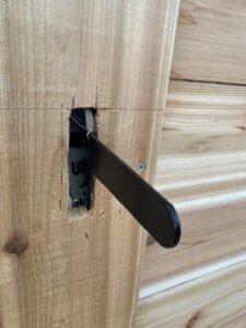 A close-up view of a newly installed gate latch on a wooden fence by Master Fences in Gaithersburg, MD.