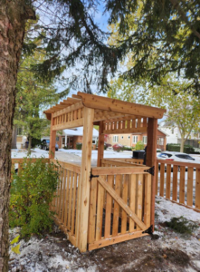 A newly installed wooden fence and gate structure with a pergola top for a residential property by ALL STAR FENCE in Chicago, IL.