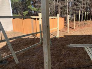 A new wooden fence installation in progress, showing posts and rails, by ETJ Fence and Restoration, INC. in Atlanta, GA.