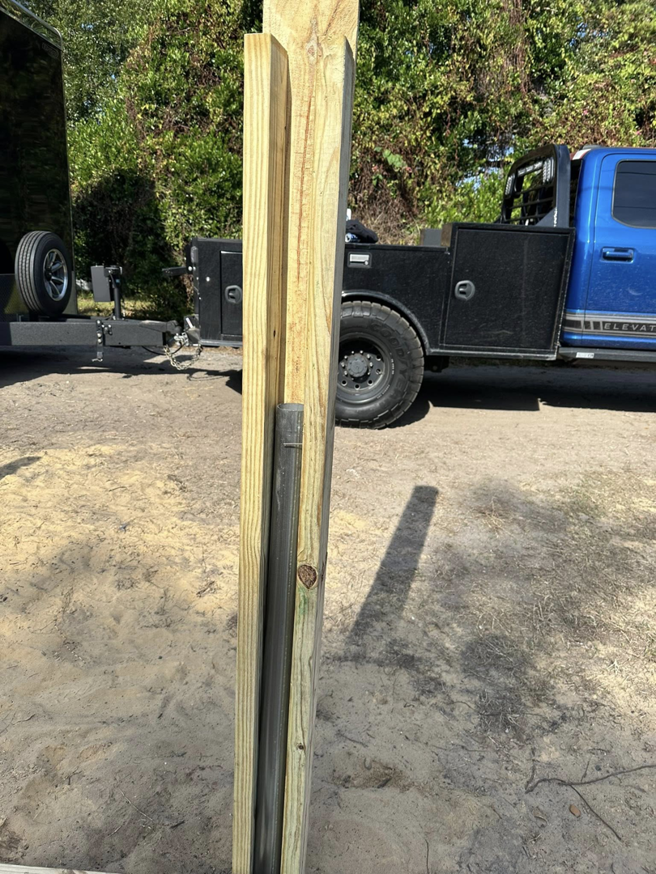 Close-up of wooden fence posts and materials ready for installation by North East Fence and Forestry in North Bay, ON.