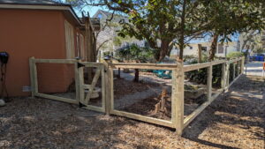 A wooden fence with wire mesh and a matching gate installed by Gifford Contracting & Repair - Custom Privacy Fencing in Goose Creek, SC.