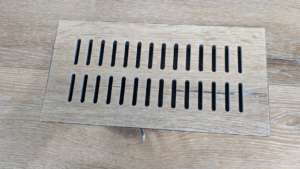 A modern wooden floor vent or register for an HVAC system by BYLT Living in Sandy, UT