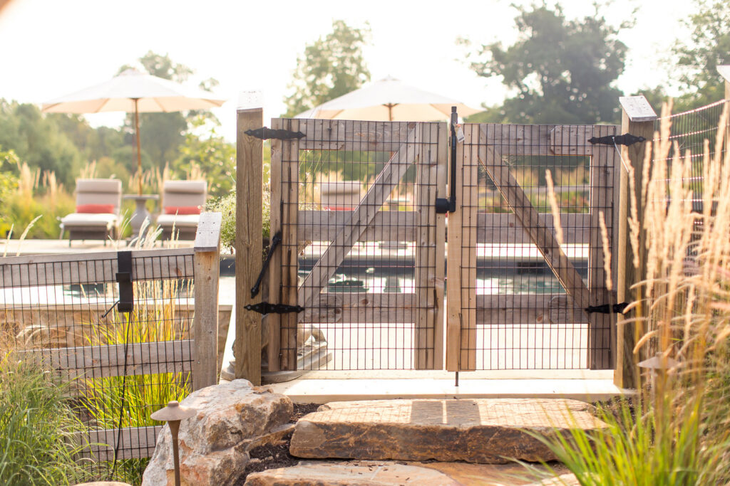 A sturdy wooden gate with wire mesh for a pool area, installed by Integrous in Gap, PA