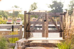 A sturdy wooden gate with wire mesh for a pool area, installed by Integrous in Gap, PA