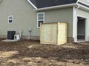 A custom-built wooden enclosure for an HVAC unit, providing aesthetic appeal and protection by Roark Fencing in Lexington, KY.