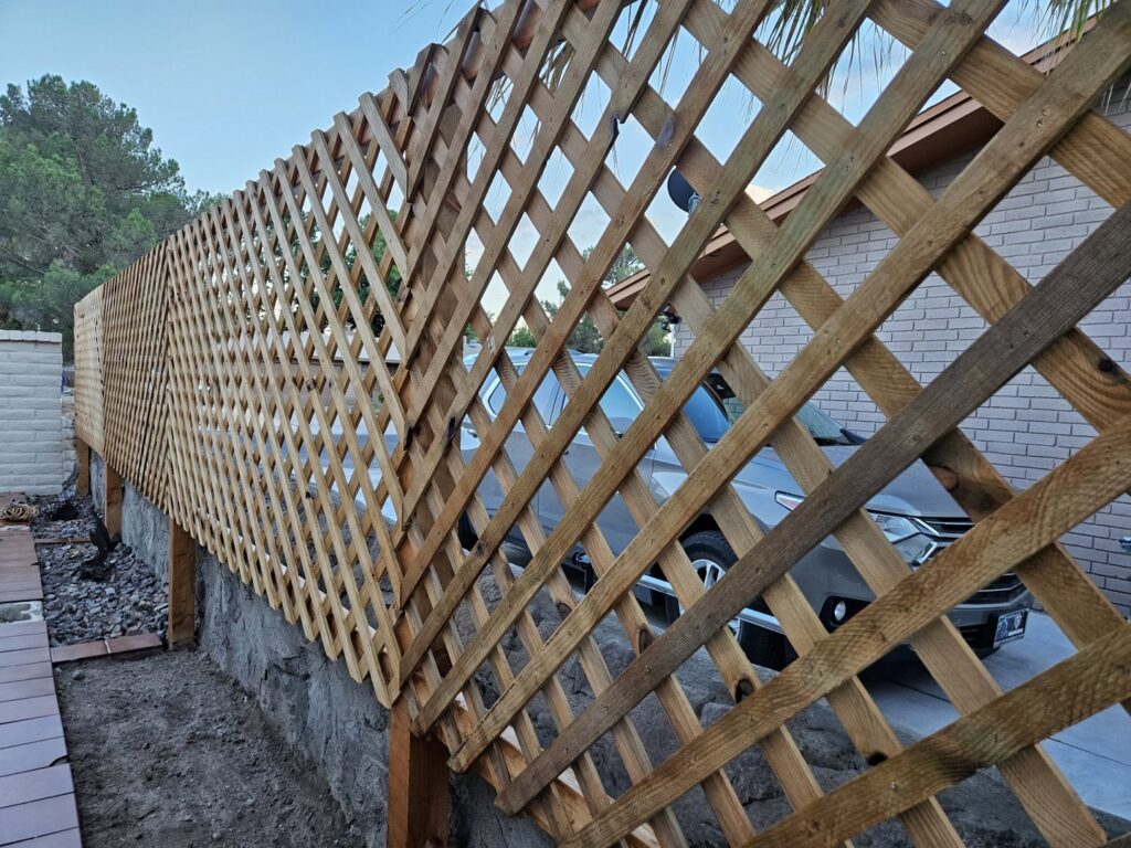 A wooden lattice privacy fence installed by Iron Man Exteriors in Las Cruces, NM.