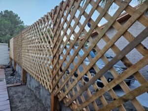 A wooden lattice privacy fence installed by Iron Man Exteriors in Las Cruces, NM.