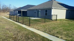 A wooden lattice privacy screen under construction next to a residential house by Best Fence & Gate LLC in Louisville, KY.