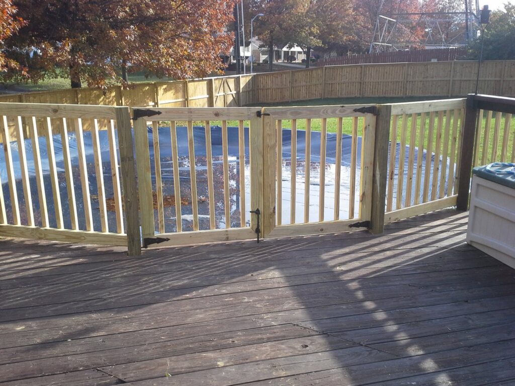 A wooden pool safety fence with two gates built around a covered above-ground pool by Border Built Fencing in Florence, KY.