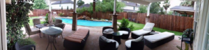A beautiful wooden privacy fence enclosing a backyard with a pool and patio by D Harley Construction in Houston, TX.