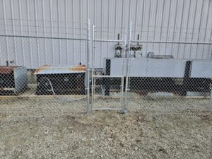 A wooden privacy fence enclosing a backyard with a hot tub and patio, installed by Hoplite Services in Indianapolis, IN.