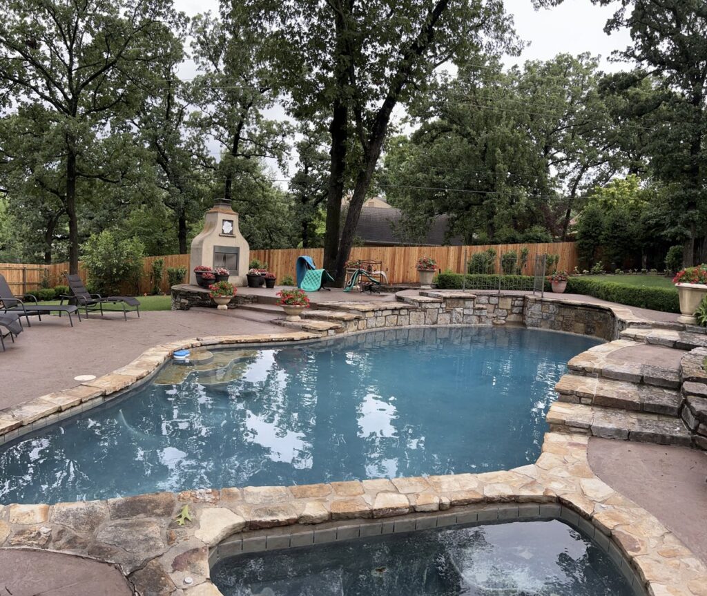 A newly installed wooden privacy fence enclosing a backyard with a swimming pool by Frontline Fence Company in Fulton, NY