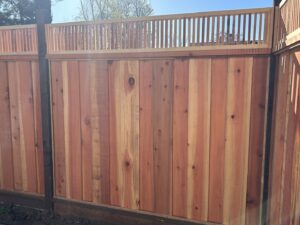 A newly installed wooden privacy fence with a decorative vertical slat top by Superior Fence & Rail in San Jose, CA.
