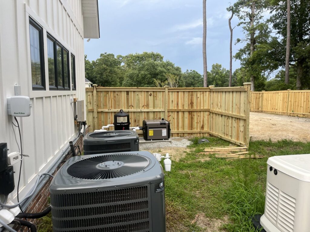 A wooden privacy fence installed to enclose HVAC units and outdoor equipment by Heavenly Gates Construction LLC in Miami, FL