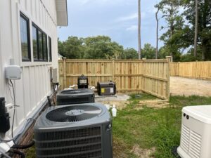 A wooden privacy fence installed to enclose HVAC units and outdoor equipment by Heavenly Gates Construction LLC in Miami, FL