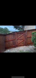 A sturdy wooden privacy fence with a custom gate installed by G Squared Fencing & Services LLC in New Braunfels, TX.