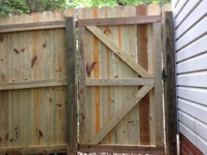 A newly installed wooden privacy fence gate by Timber Fencing in Charlotte, NC.
