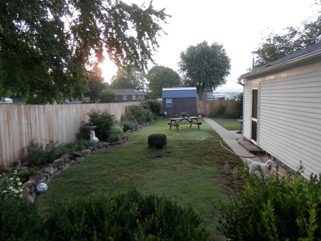A sturdy wooden privacy fence enclosing a backyard, installed by Petty Fence Company LLC in Evansville, IN.