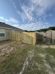 A new wooden privacy fence installed by Littleton Construction LLC, connecting to an existing fence in the Service Area.
