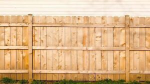 A classic wooden privacy fence installed in a residential setting by Triple P Fence in Augusta, ME.