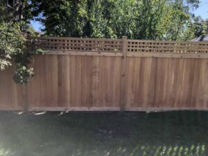 A wooden privacy fence with a lattice top enclosing a backyard by Freeman Fence in Atlanta, GA.