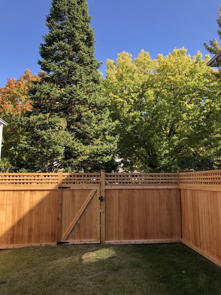 A wooden privacy fence with a lattice top and matching gate installed by Freeman Fence in Atlanta, GA.